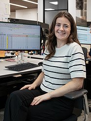 A woman sitting in front of her desk in the office