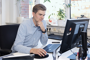 Finn in the office in front of a computer