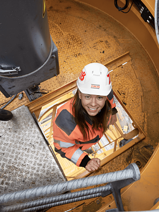 A STRABAG employee climbing up a latter