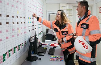 Three colleagues discuss together on the construction site in Oman