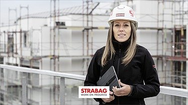 Video woman with helmet on construction site