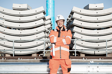 Planning manager in workwear in front of construction materials