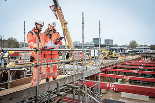 Two colleagues in conversation together at the workplace