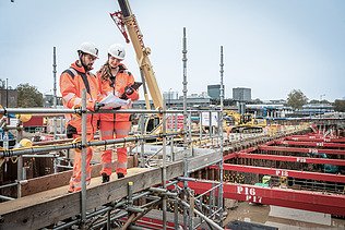 Two colleagues in conversation together at the workplace