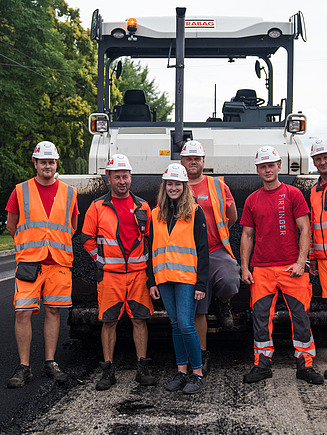 Image of employees in front of the machine
