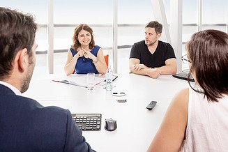 Four people having a meeting in an office.