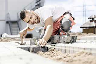 Photo: Marcel Voth laying paving stones