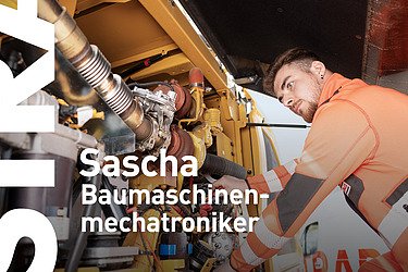 Mann repariert eine Baumaschine