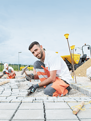 Paver working with a hammer on the street.