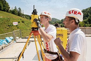 Photo: An apprentice looks through a measuring device