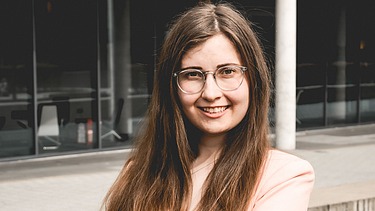 Vanessa stands in front of a building