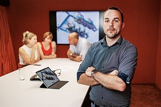 Male employee in the meeting room of the STRABAG headquarters in Cologne