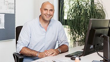 Aykut sitting in the office