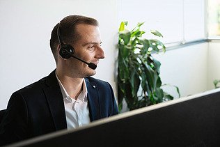 Photo man with head set sitting at screen