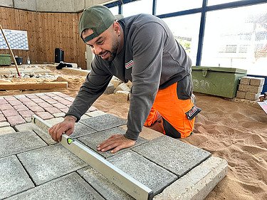Kazim, road construction apprentice paving