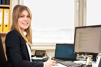 Industrial clerk trainee at ZÜBLIN Timber Employee at her workplace in the office