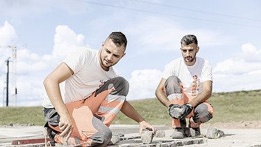 Picture of Marcel Voth with a colleague during training as a road builder