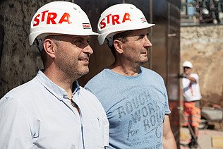 Foto Zwei Männer mit Helm schauen nach rechts oben