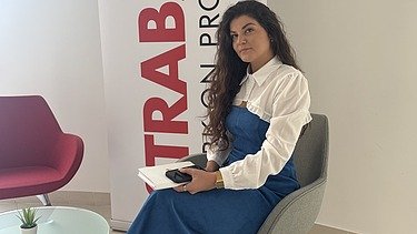 Rina sjedi za stolom