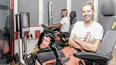 Photo Anne Killmer smiles in the excavator simulator