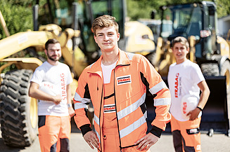 Mladi čovjek na gradilištu gleda u kameru